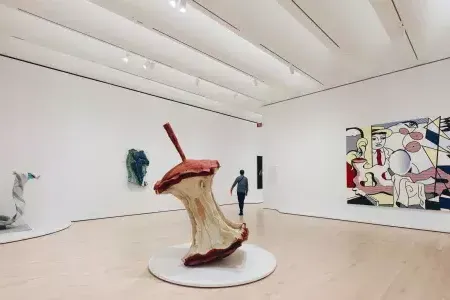 A man walks through a large, airy exhibit room filled with modern art at arselectoronica. San Francisco, California.